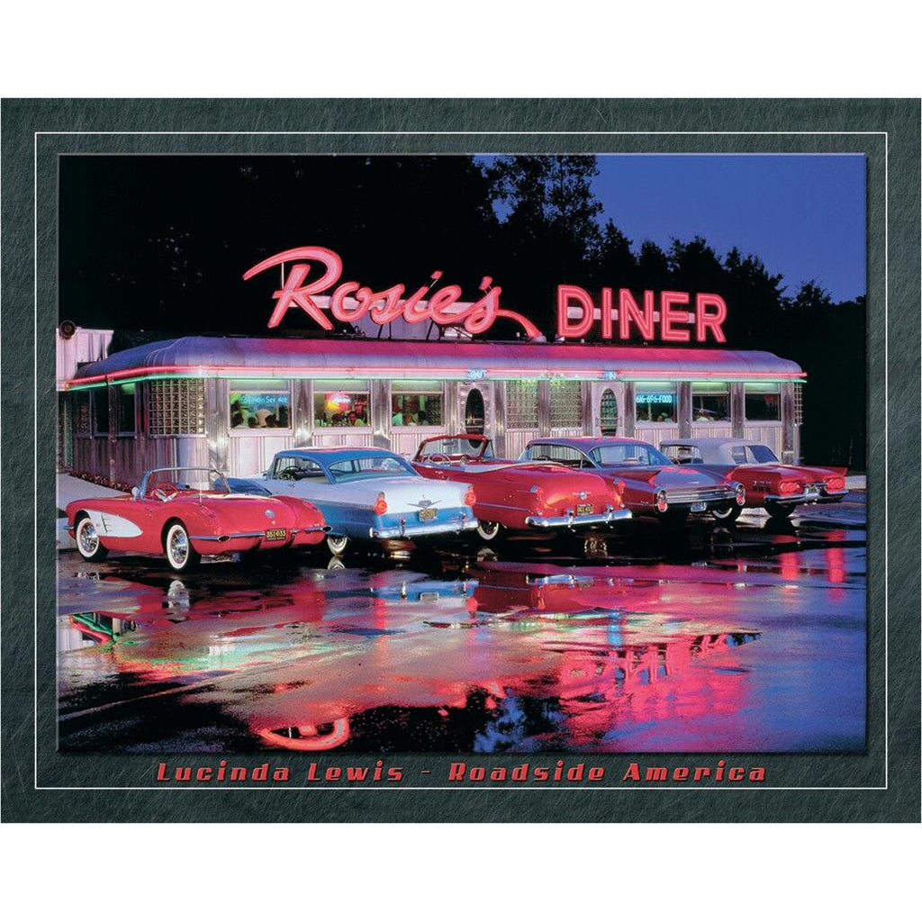 Vintage diner with classic cars in front, illuminated by neon lights at night.