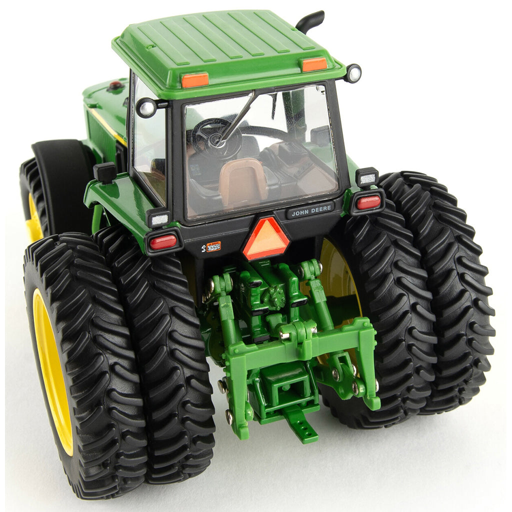 Model of a green John Deere 4960 tractor with yellow wheels on a white background