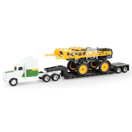Toy truck with a flatbed carrying a larger toy Hagie sprayer on a white background