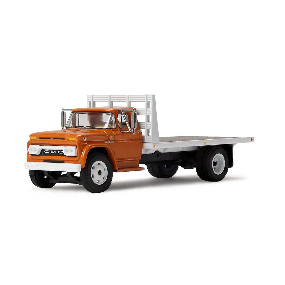 An orange GMC flatbed truck model with a white flatbed and white wheels, shown on a clean white background.