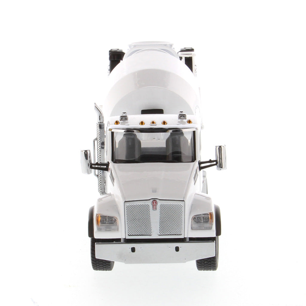 A white die-cast model of a Kenworth truck with a cement mixer drum, photographed on a seamless white background.