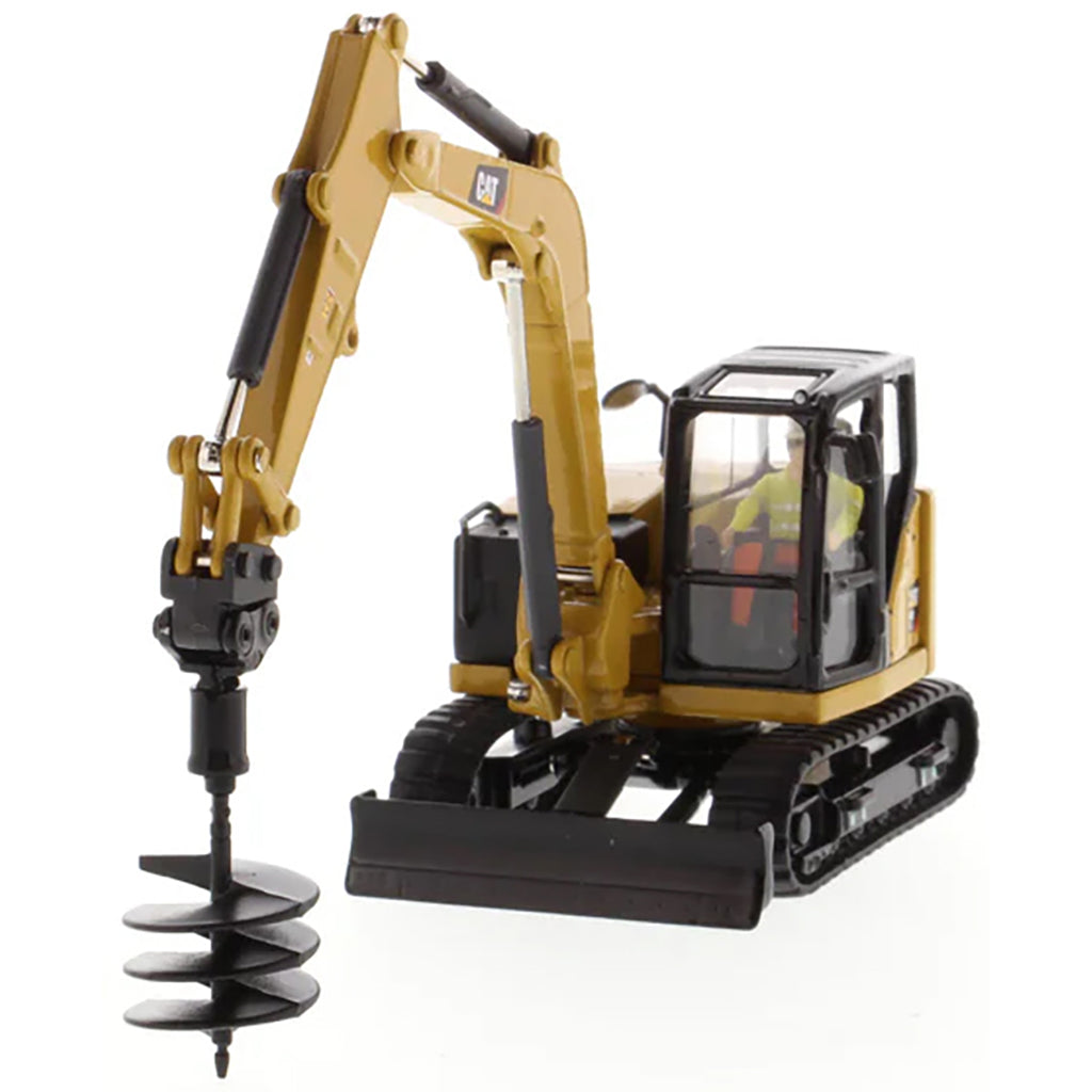 Model of a Caterpillar 308 CR Mini Hydraulic Excavator with Operator on a White Background