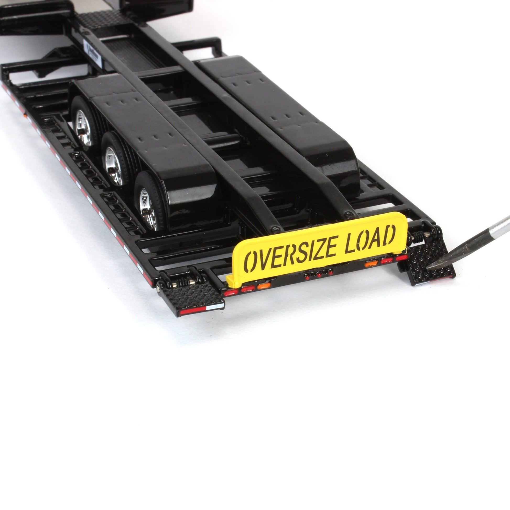 Black trailer with 'Oversize Load' sign on a white background