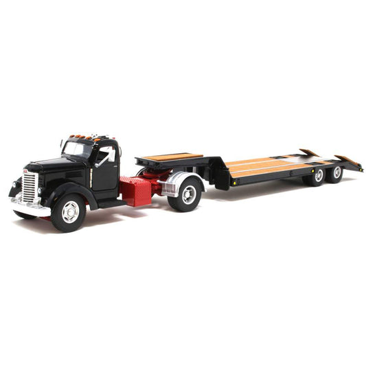 Model of an old-fashioned international kb-8 black tractor with a black lacrosse lowboy trailer on a white background