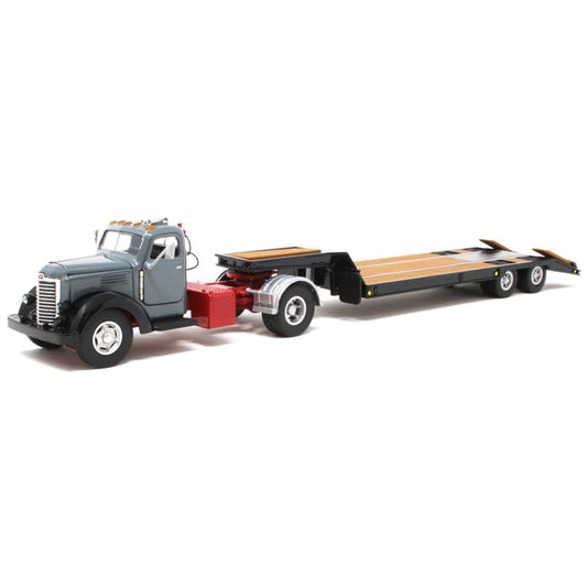 Model of an old-fashioned international kb-8 gray tractor with a black lacrosse lowboy trailer on a white background