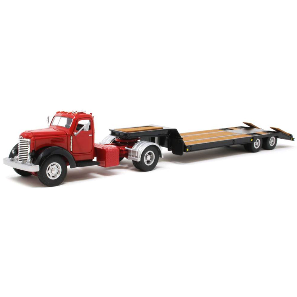 Model of an old-fashioned international kb-8 red tractor with a black lacrosse lowboy trailer on a white background