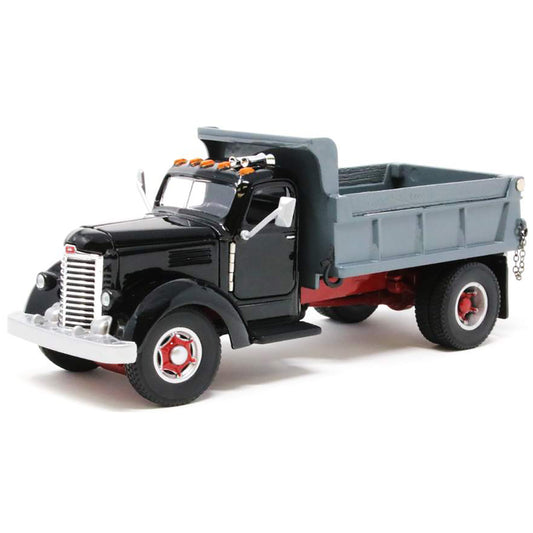 Model of an old-fashioned international kb-8 black dump truck with a gray bed on a white background
