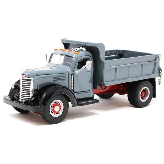Model of an old-fashioned international kb-8 gray dump truck with a gray bed on a white background