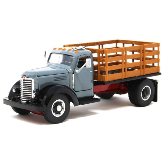 Model of an old-fashioned international kb-8 gray stakebed truck with a black bed on a white background