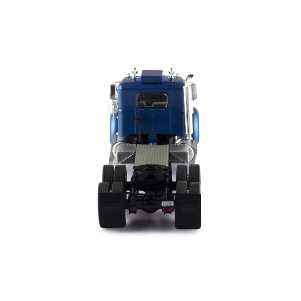Model of a blue and silver Autocar truck on a white background