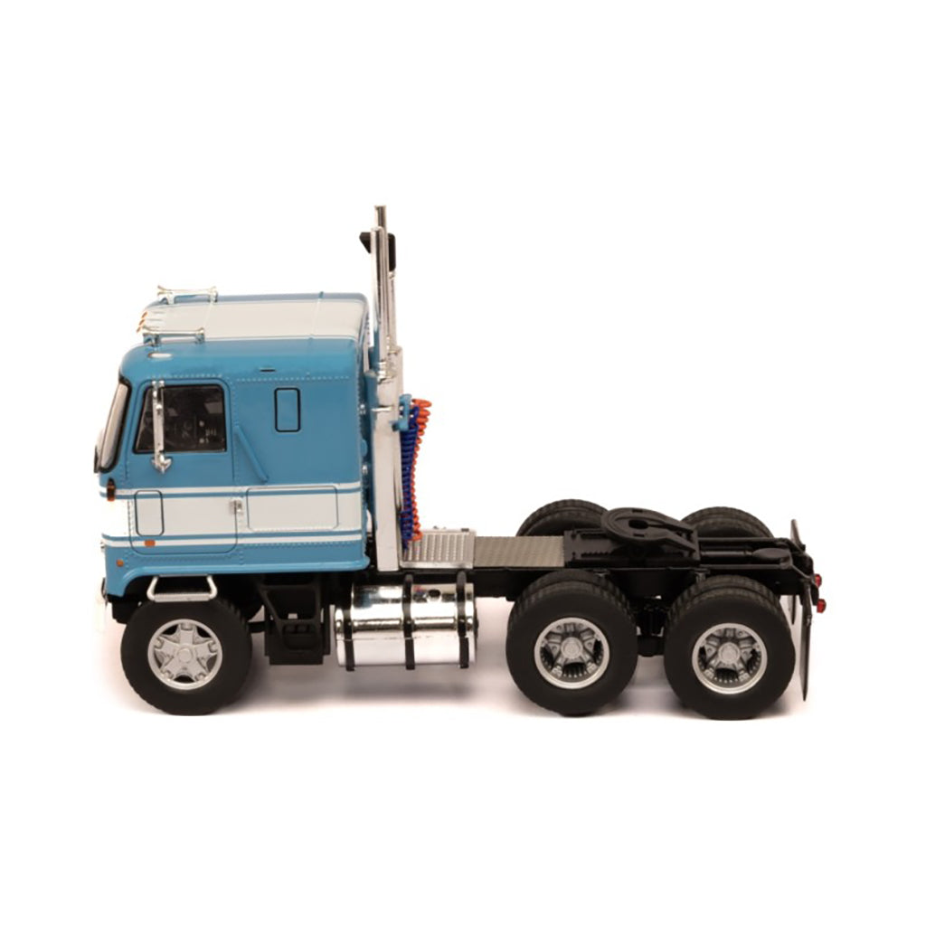 Model of a blue and white GMC Astro Cab Over truck on a white background