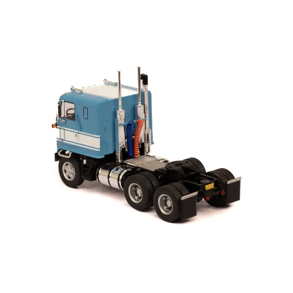 Model of a blue and white GMC Astro Cab Over truck on a white background