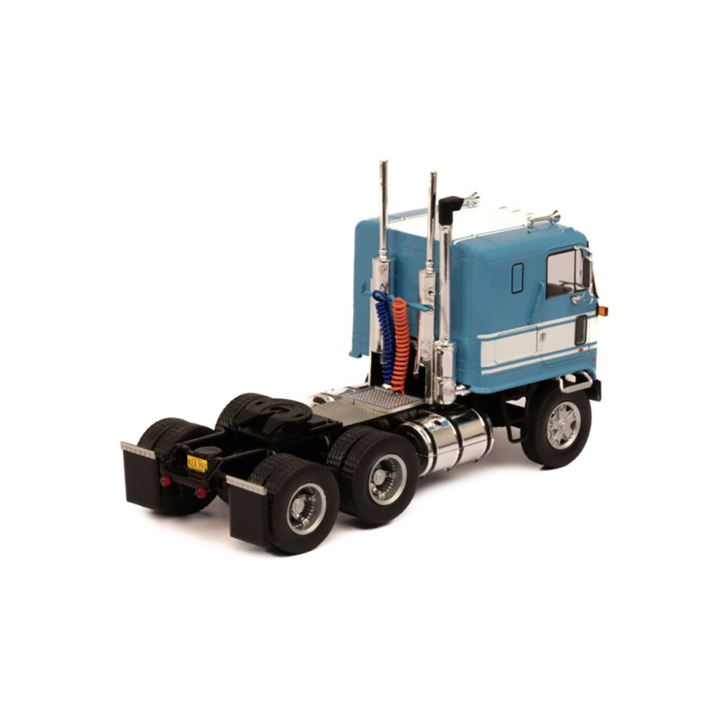 Model of a blue and white GMC Astro Cab Over truck on a white background