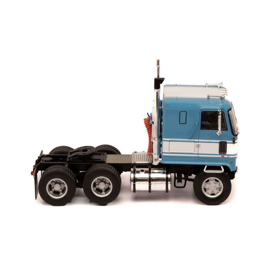 Model of a blue and white GMC Astro Cab Over truck on a white background
