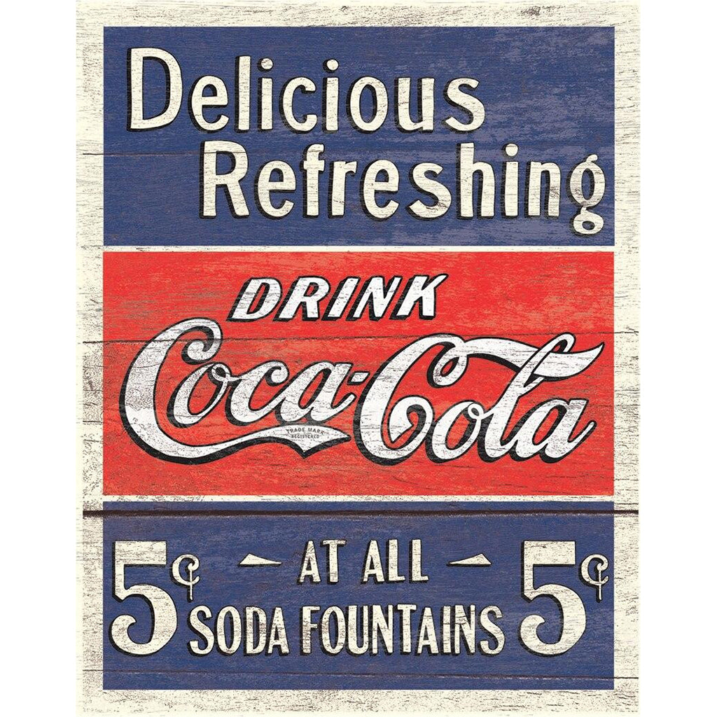Vintage Coca-Cola sign with red, white, and blue colors on a wooden background.