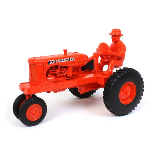 Orange toy tractor with a driver figure on a white background