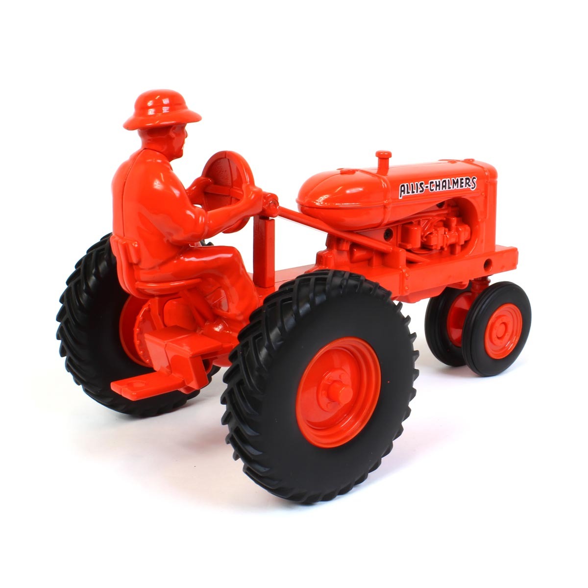 Orange toy tractor with a driver figure on a white background