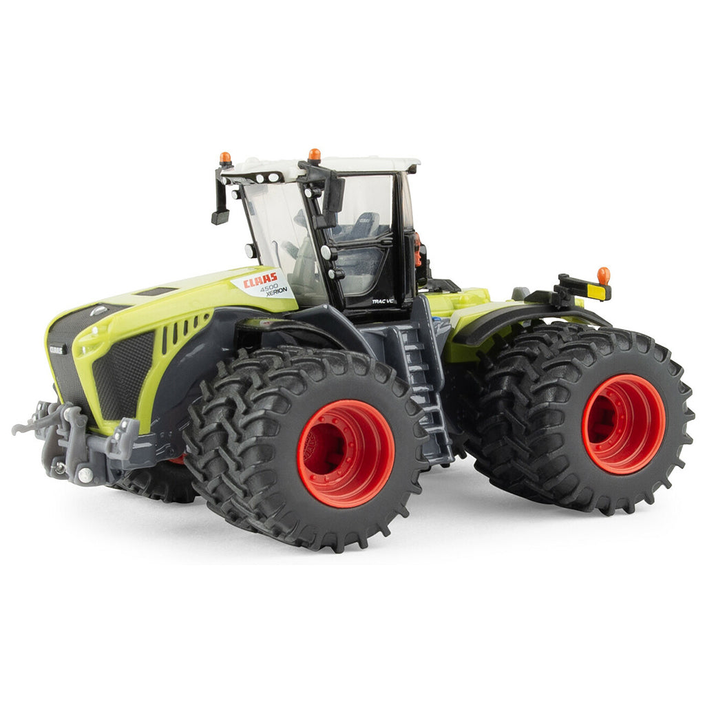 Model of a large Claas agricultural tractor with prominent wheels on a white background