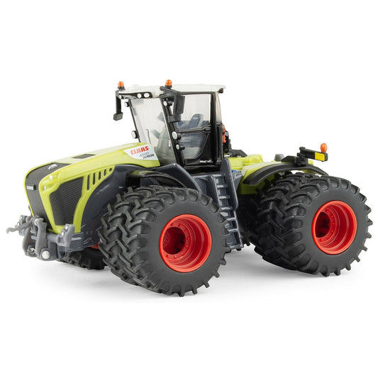 Model of a large Claas agricultural tractor with prominent wheels on a white background