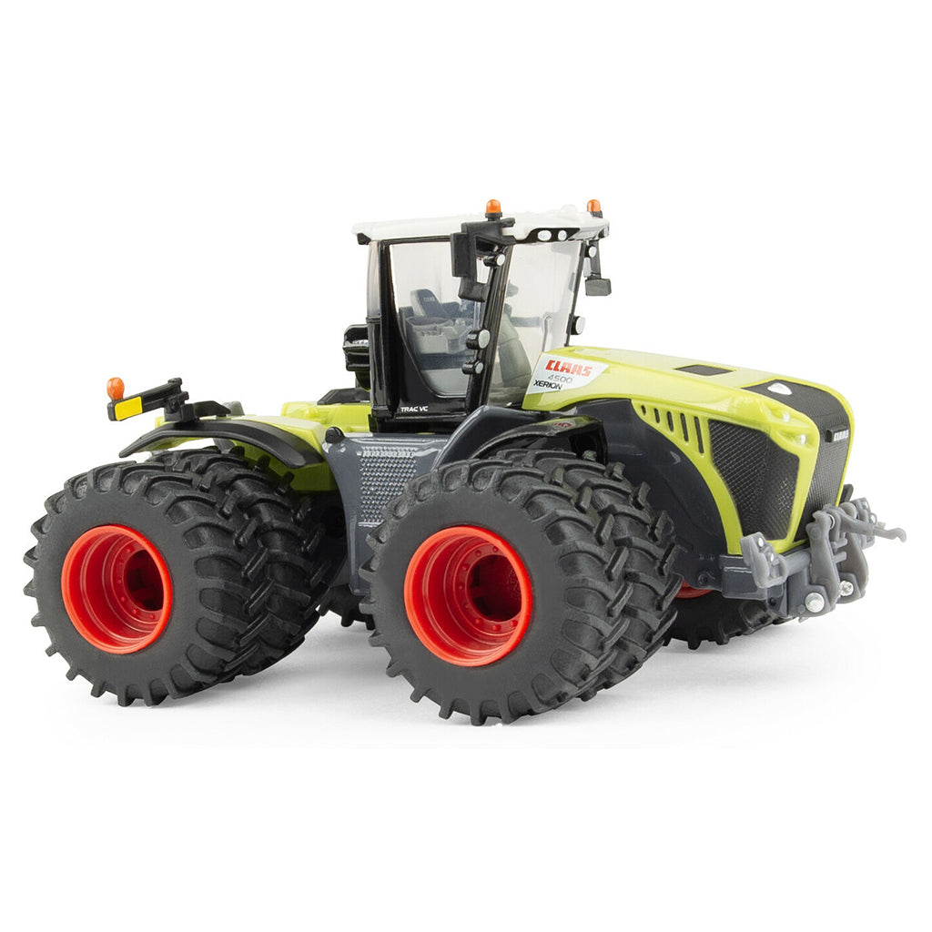 Model of a large Claas agricultural tractor with prominent wheels on a white background
