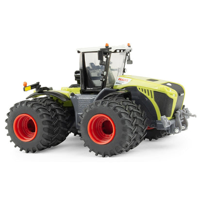 Model of a large Claas agricultural tractor with prominent wheels on a white background