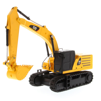 A yellow and black CAT toy remote control excavator with a bucket attachment, photographed on a clean white background.