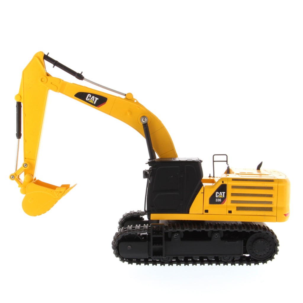A yellow and black CAT toy remote control excavator with a bucket attachment, photographed on a clean white background.