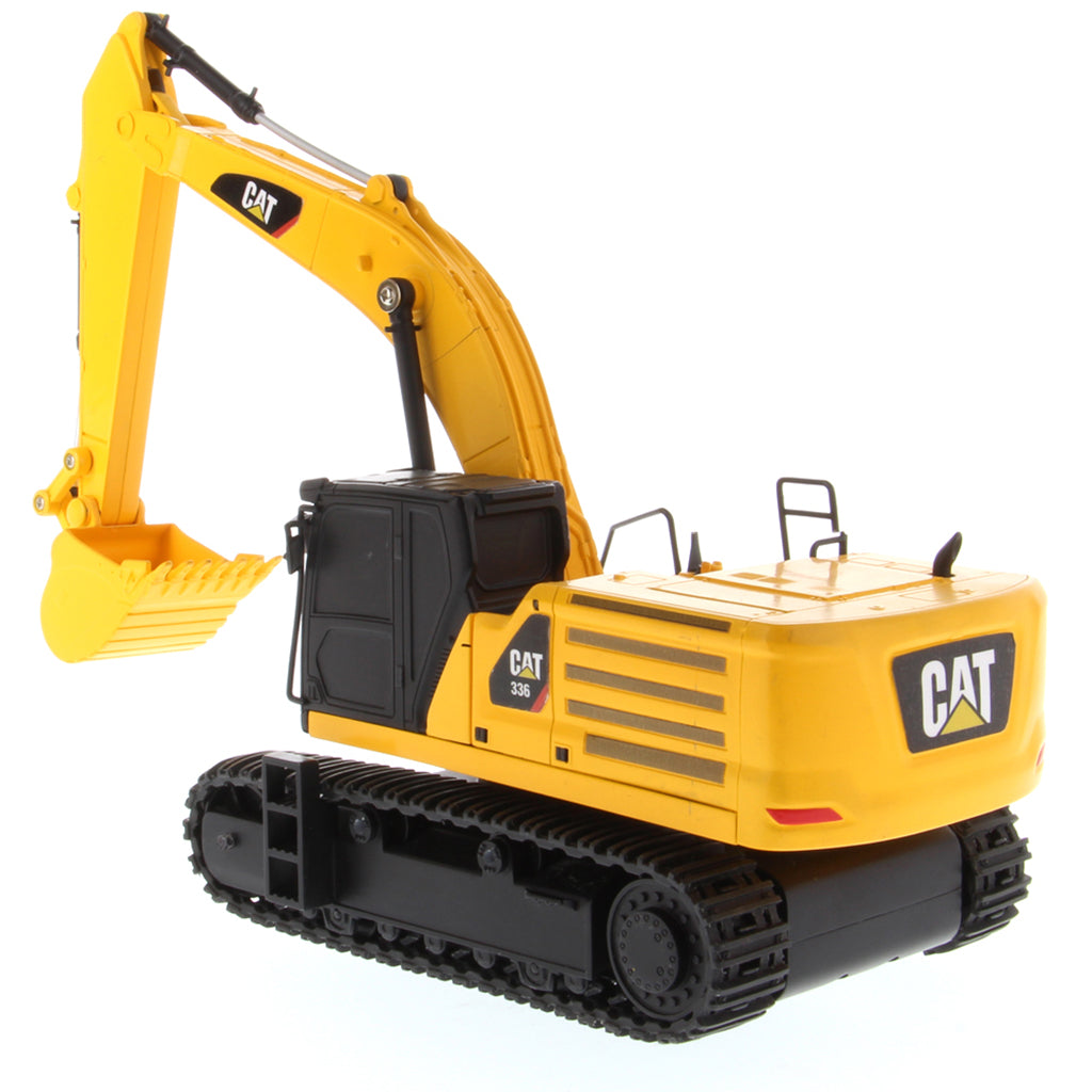 A yellow and black CAT toy remote control excavator with a bucket attachment, photographed on a clean white background.