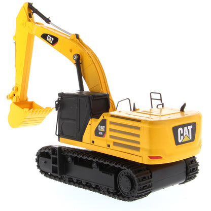 A yellow and black CAT toy remote control excavator with a bucket attachment, photographed on a clean white background.