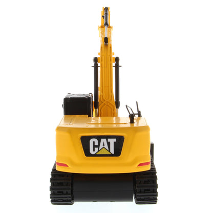 A yellow and black CAT toy remote control excavator with a bucket attachment, photographed on a clean white background.