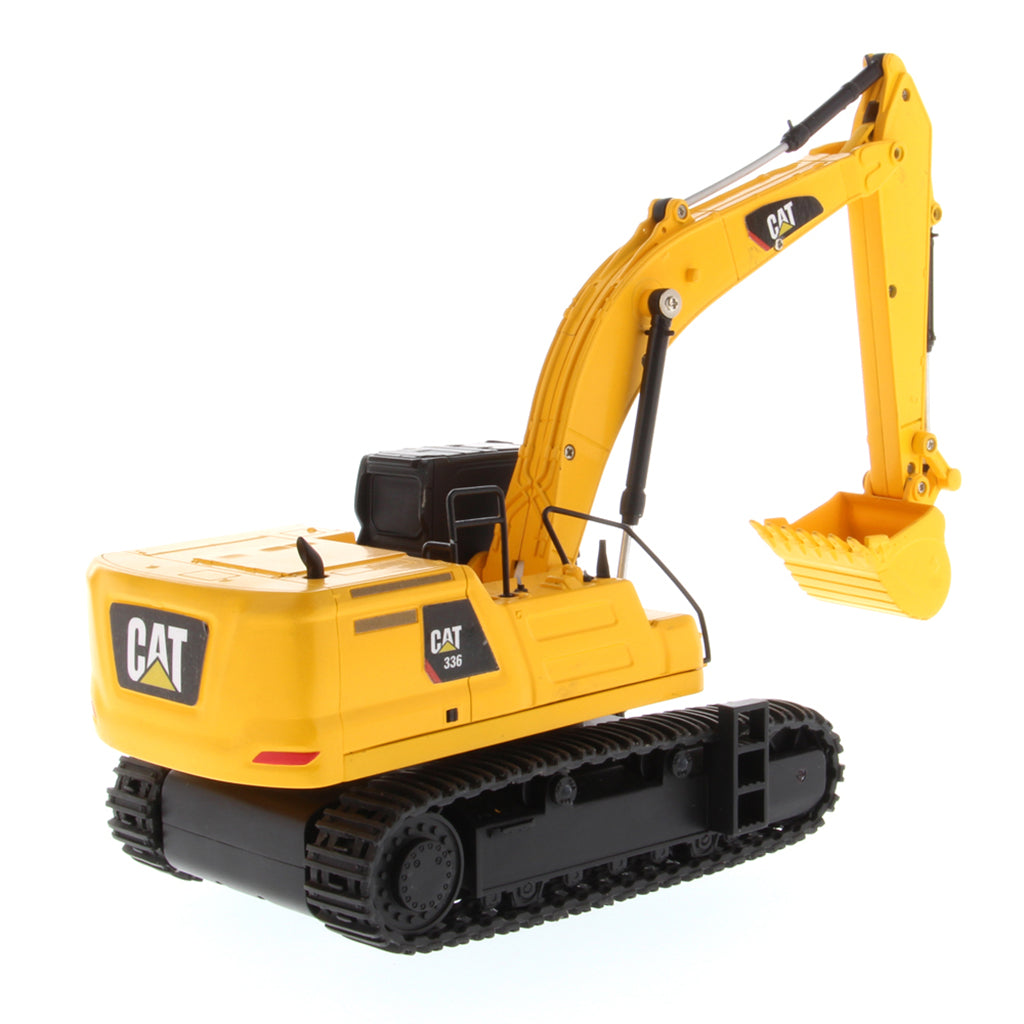 A yellow and black CAT toy remote control excavator with a bucket attachment, photographed on a clean white background.