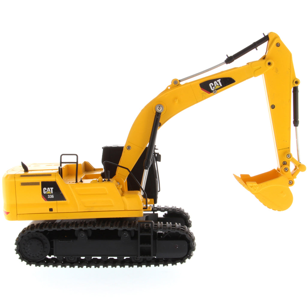 A yellow and black CAT toy remote control excavator with a bucket attachment, photographed on a clean white background.