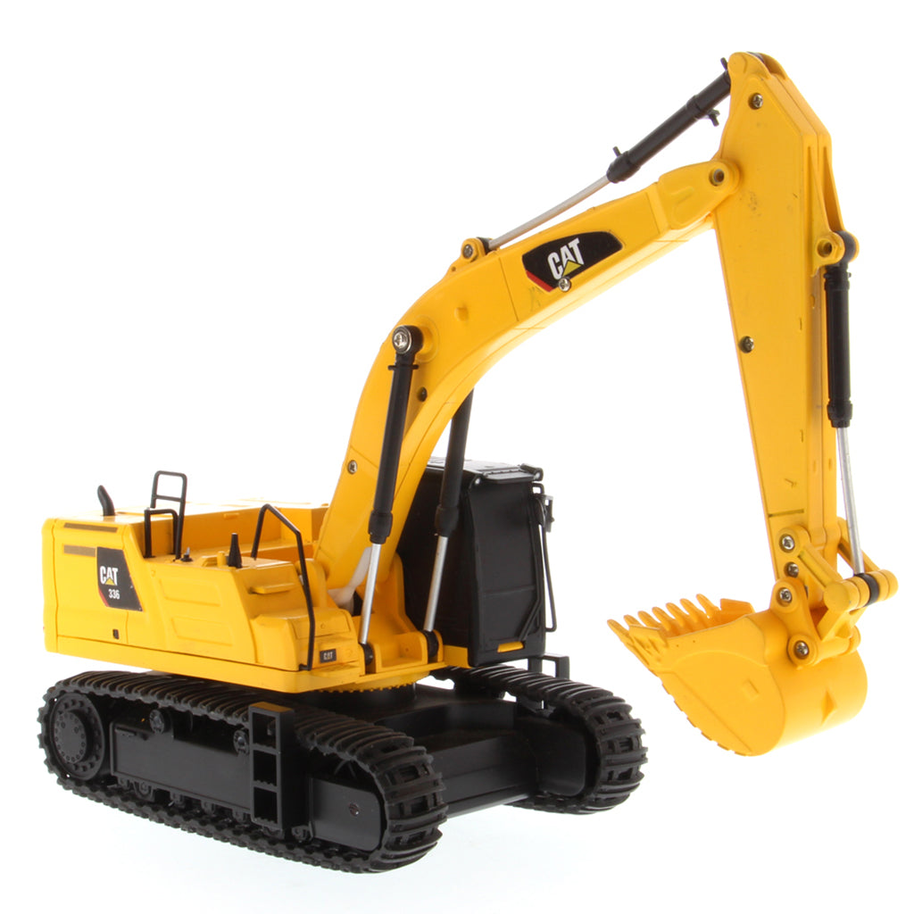 A yellow and black CAT toy remote control excavator with a bucket attachment, photographed on a clean white background.