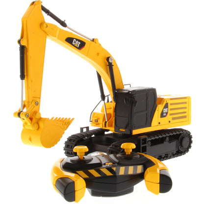 A yellow and black CAT toy remote control excavator with a bucket attachment, photographed on a clean white background.