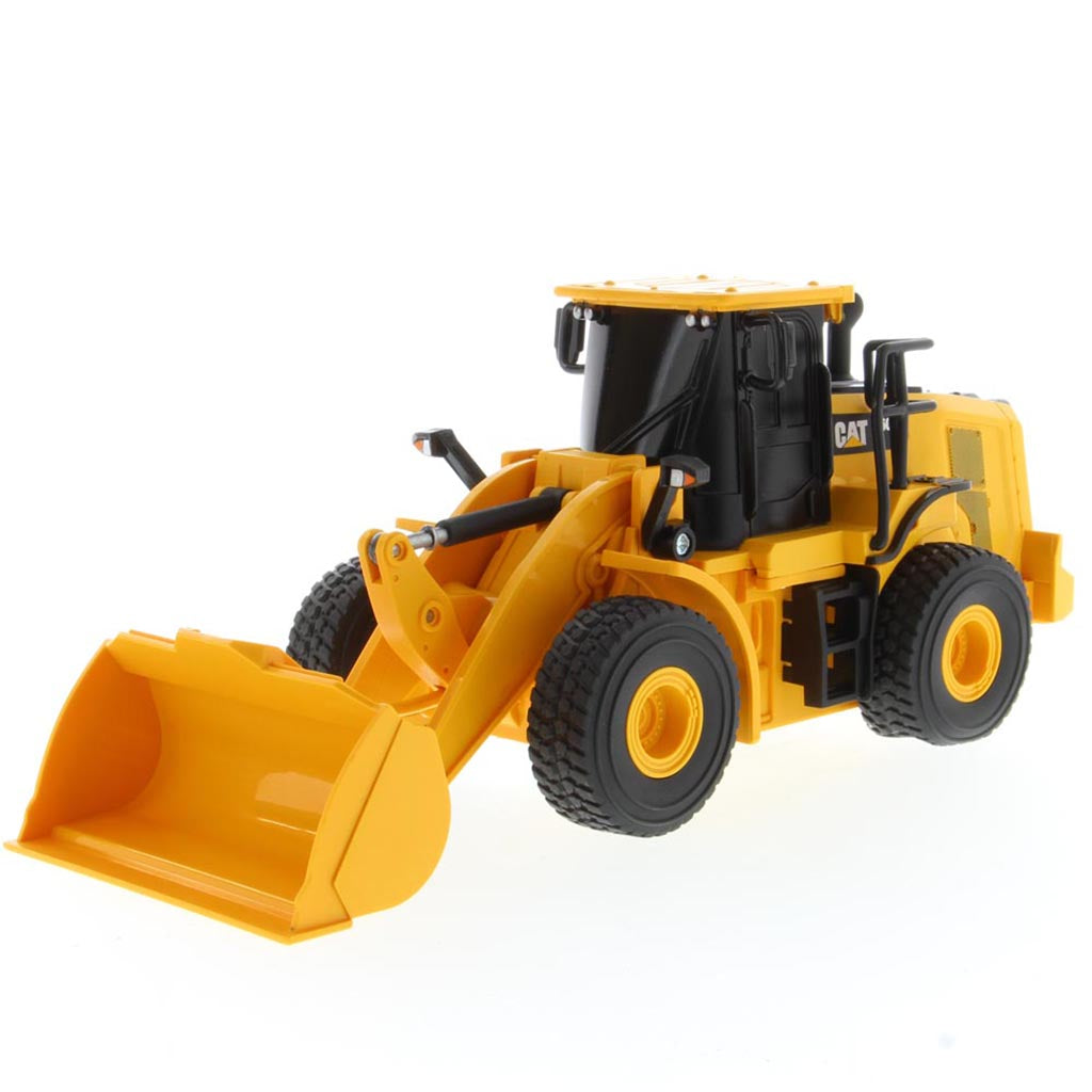 A yellow and black radio controlled wheel loader with a front bucket loader, photographed on a clean white background. The brand name CAT is visible on the side of the cab.