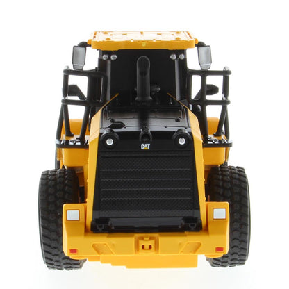 A yellow and black radio controlled wheel loader with a front bucket loader, photographed on a clean white background. The brand name CAT is visible on the side of the cab.