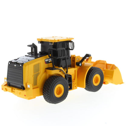A yellow and black radio controlled wheel loader with a front bucket loader, photographed on a clean white background. The brand name CAT is visible on the side of the cab.