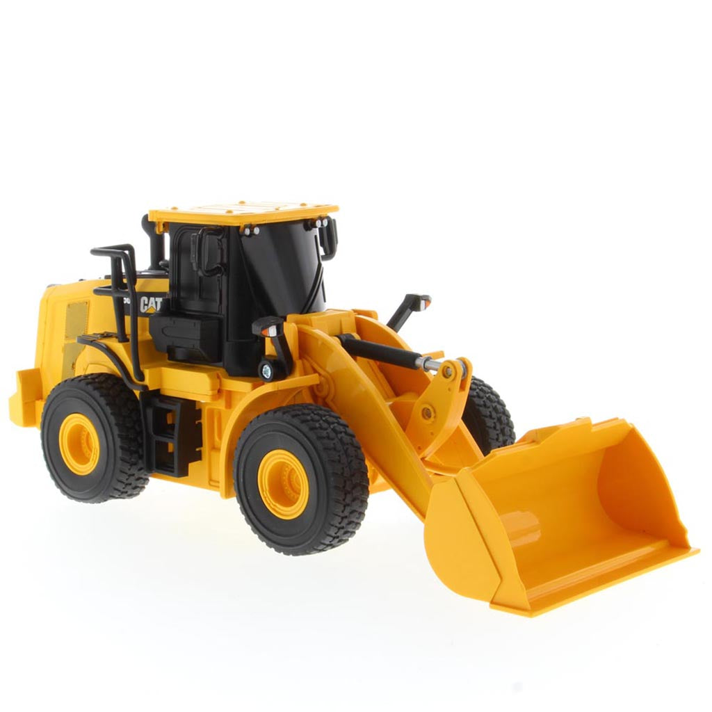 A yellow and black radio controlled wheel loader with a front bucket loader, photographed on a clean white background. The brand name CAT is visible on the side of the cab.