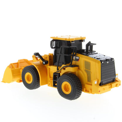 A yellow and black radio controlled wheel loader with a front bucket loader, photographed on a clean white background. The brand name CAT is visible on the side of the cab.