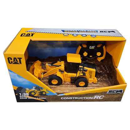 CAT brand 1:35 scale remote control toy dump truck in its original yellow and black retail packaging box, featuring a yellow and black toy loader and a matching remote control inside a simulated dirt track display.