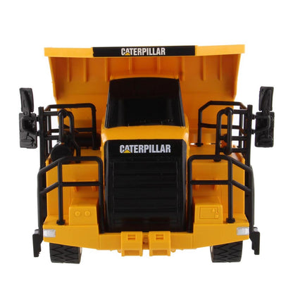 Toy Remote Controlled Yellow and Black Caterpillar 770 Dump Truck on a White Background