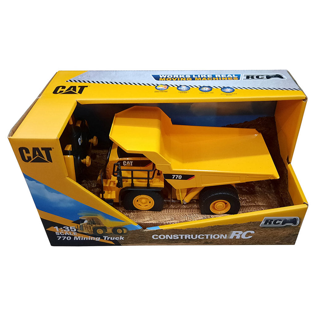 Yellow toy dump truck in a CAT branded box on a white background