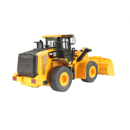 Radio controlled model of a CAT yellow & black Caterpillar 950M wheel loader on a white background