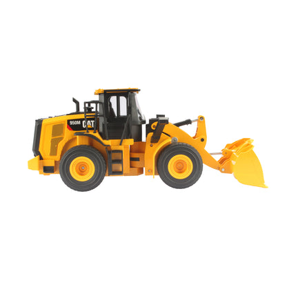 Radio controlled model of a CAT yellow & black Caterpillar 950M wheel loader on a white background