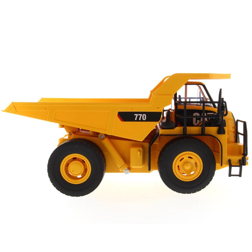 Yellow and Black Remote Controlled Model of a Caterpillar 770 Mining Dump Truck on a White Background