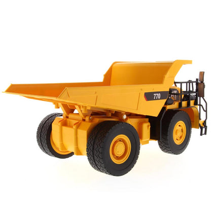 Yellow and Black Remote Controlled Model of a Caterpillar 770 Mining Dump Truck on a White Background