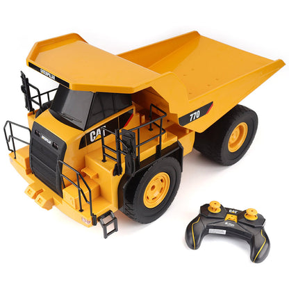 Radio Controlled Model of a CAT Yellow Caterpillar 770 Off-Highway Dump Truck with Controller on a White Background