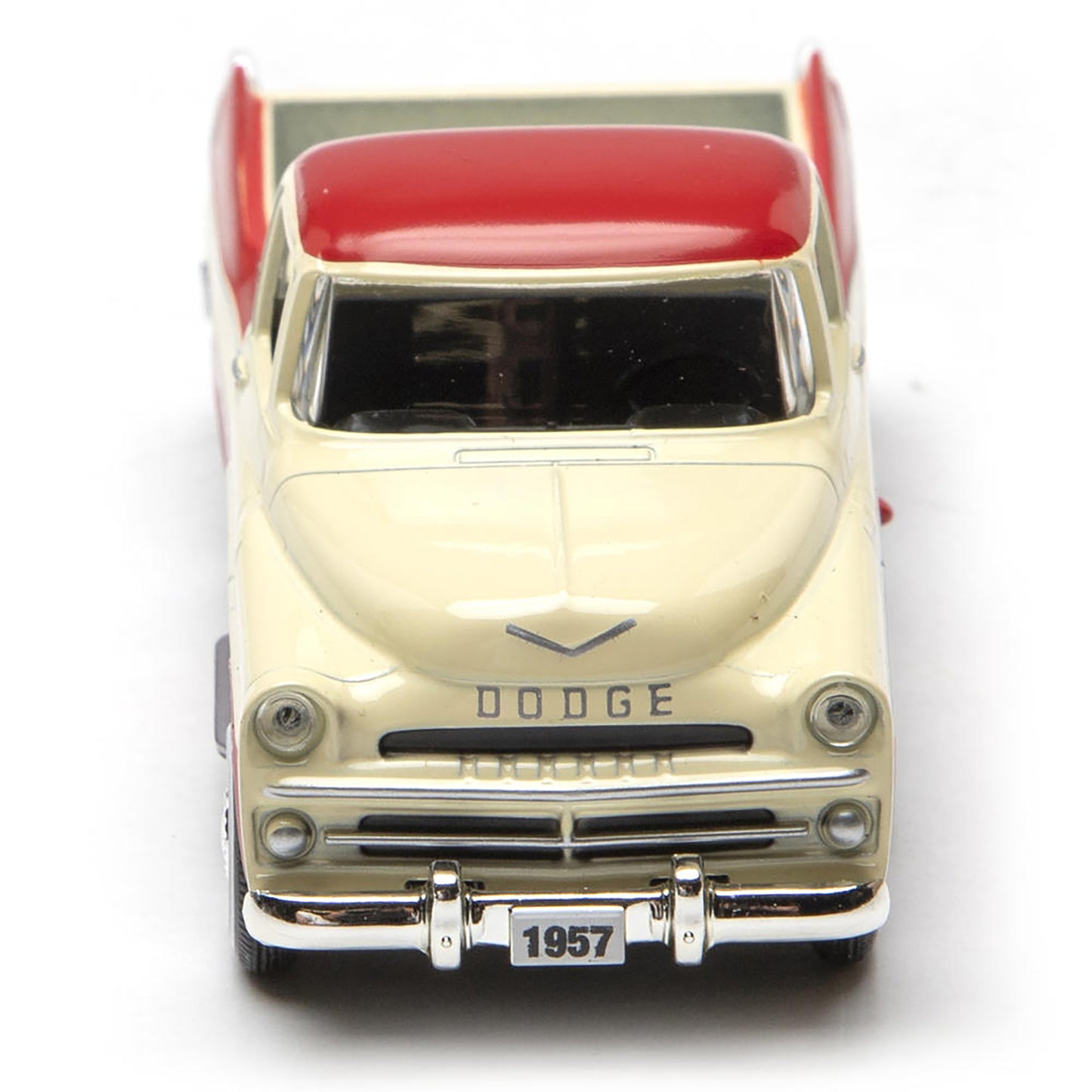 Model of a 1957 Dodge truck with a red bed on a white background