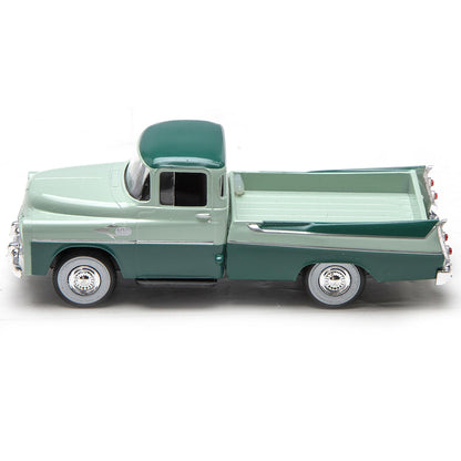 Model of a vintage green pickup truck on a white background