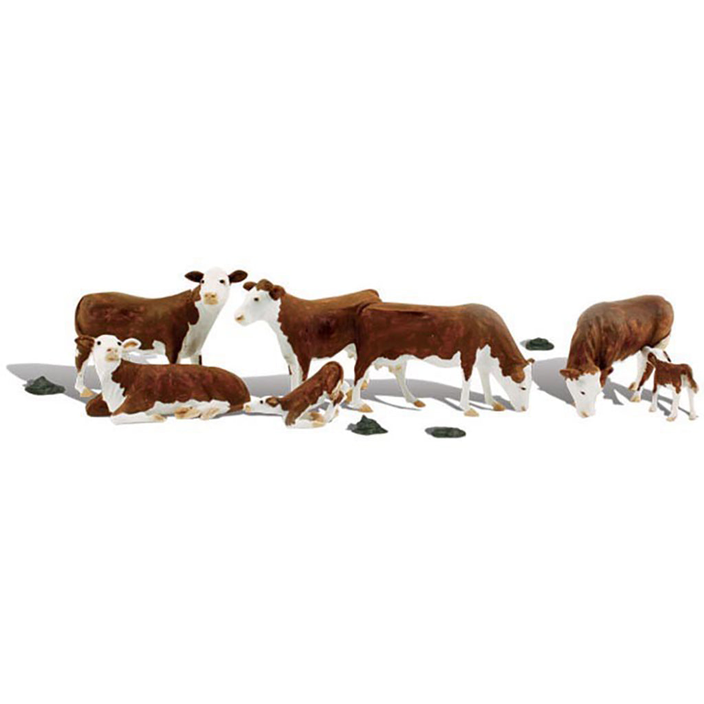 A set of realistic cow figurines depicting a herd with adults, calves, and a lying cow, arranged on a plain white background.